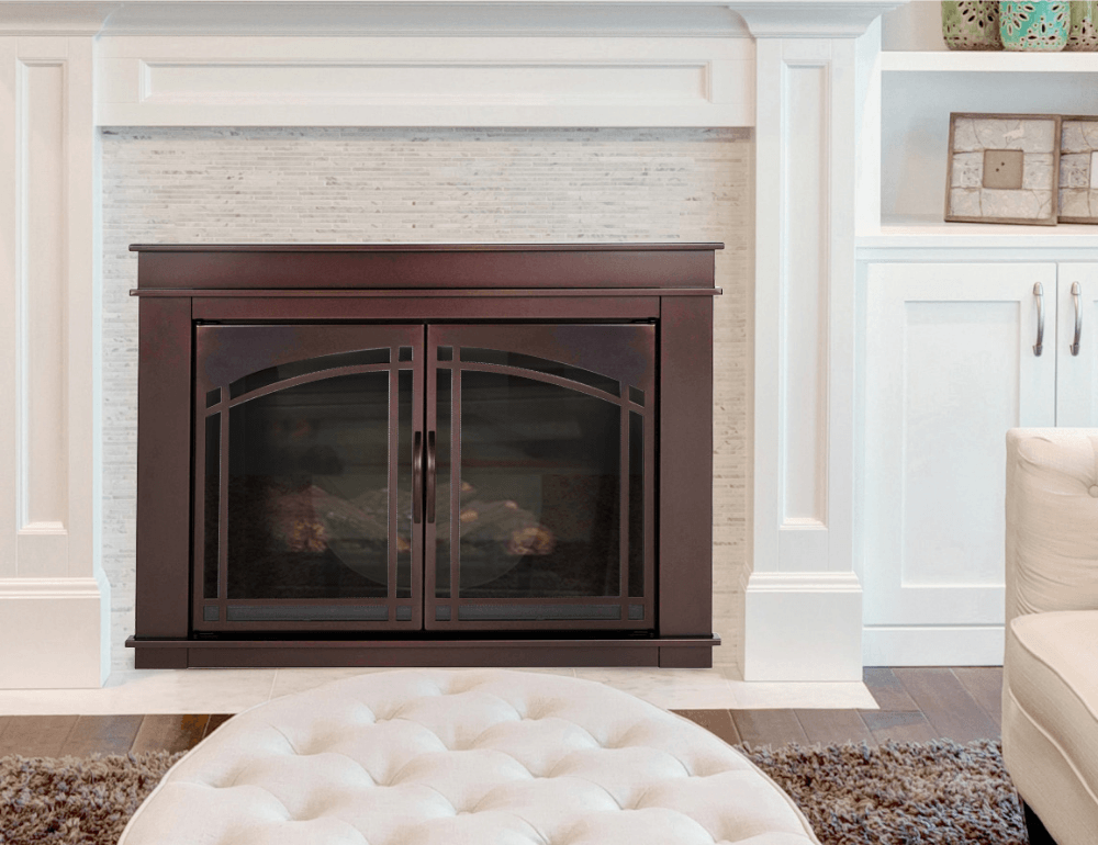 Dark wood fireplace with glass doors, white mantle, and built-in shelving.