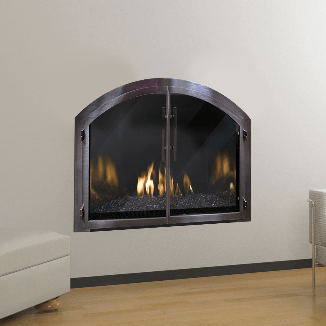 A gas fireplace with arched, glass doors, flames, and a dark metal frame against a beige wall.