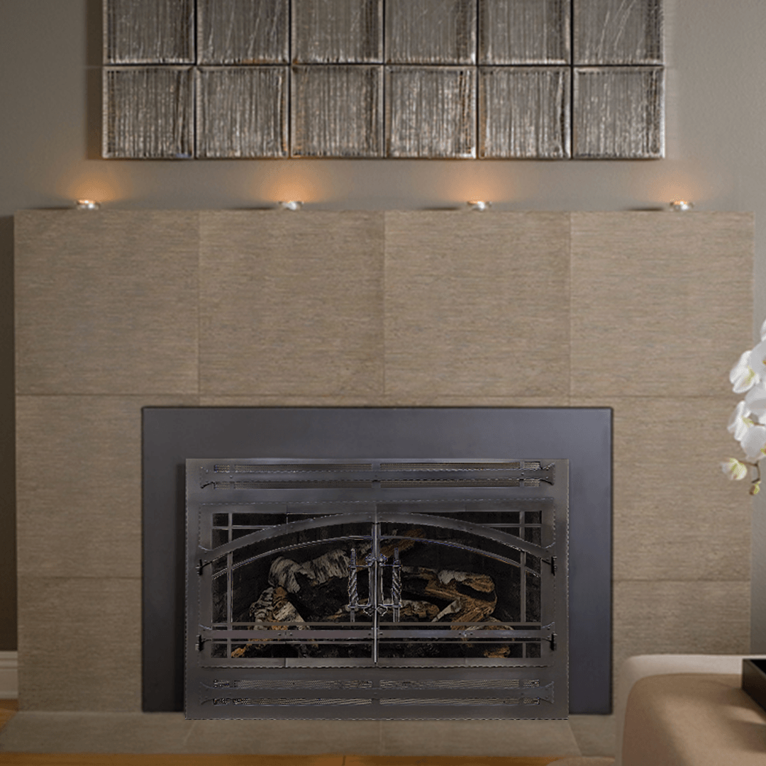 Fireplace with beige tile surround, metal firebox, and decorative art above.