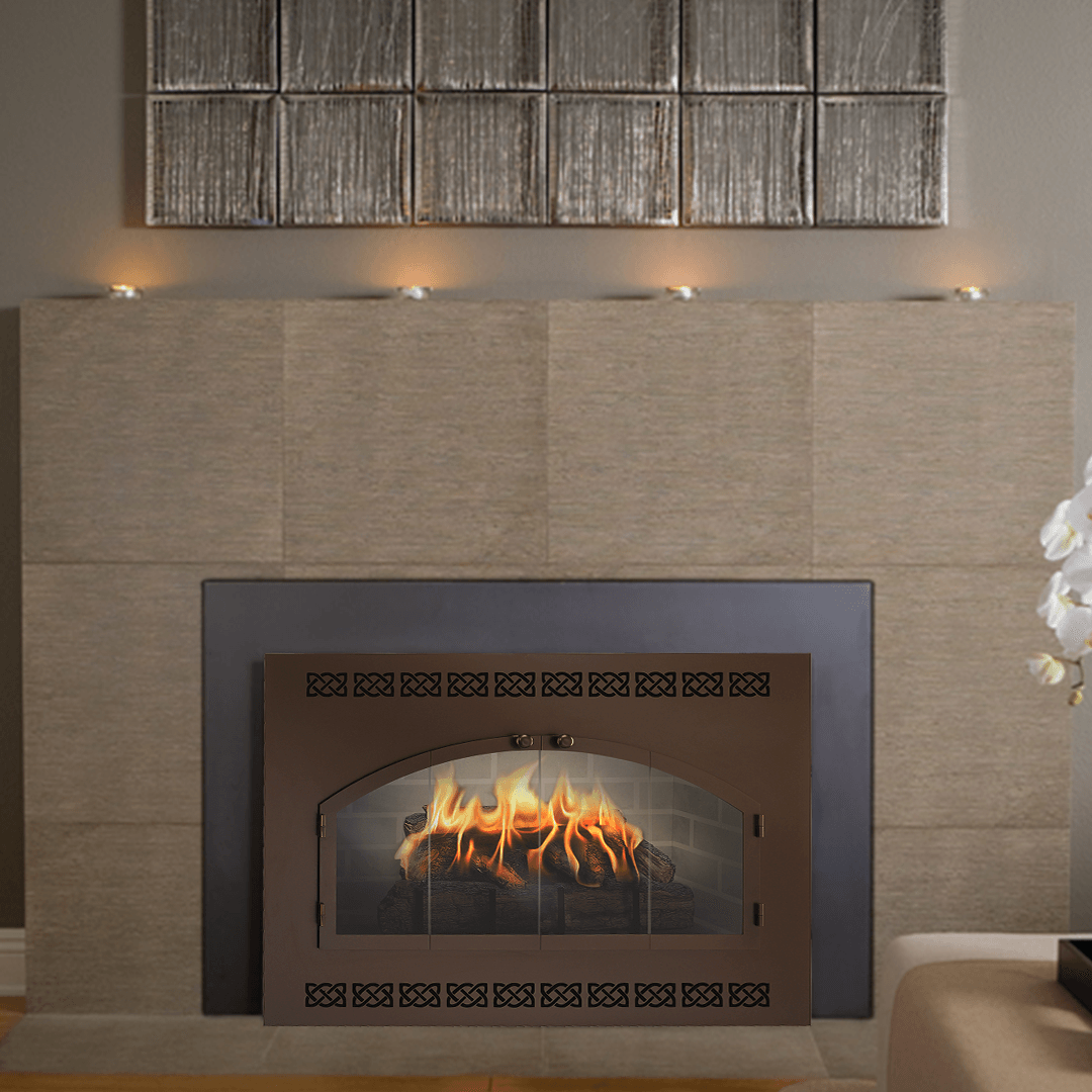 Fireplace with flames behind a brown metal door, tan tiled surround, and decorative candles above.