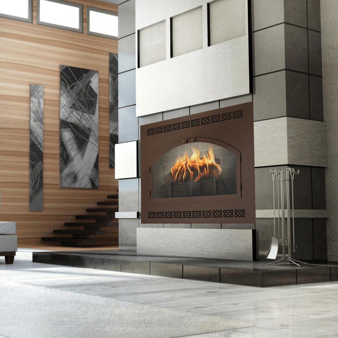 Fireplace with burning flames, brown metal surround, in a modern room with wood paneling and stone.