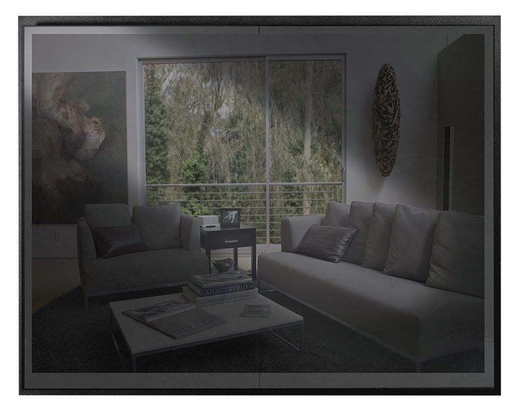 Living room with sofa, chairs, and coffee table; large window with trees.