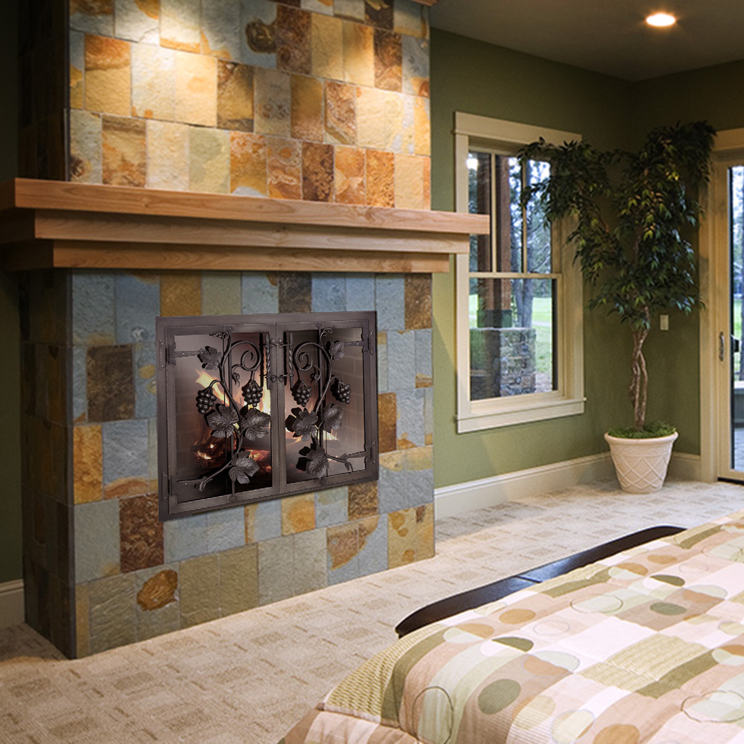 Fireplace with stone surround, wooden mantel, and decorative screen in a room with green walls.