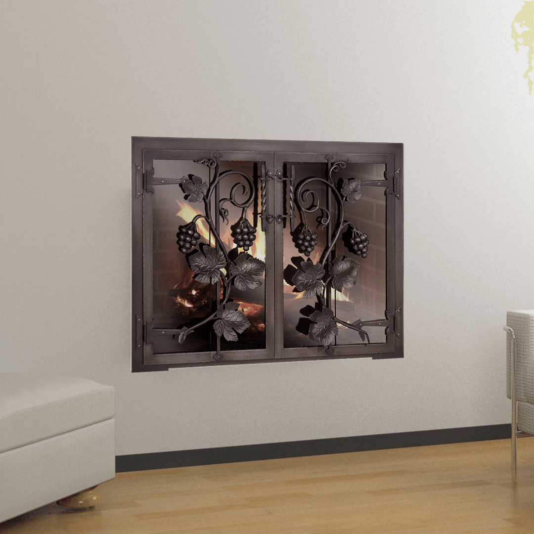 Fireplace with grape vine design, black metal doors on a white wall.