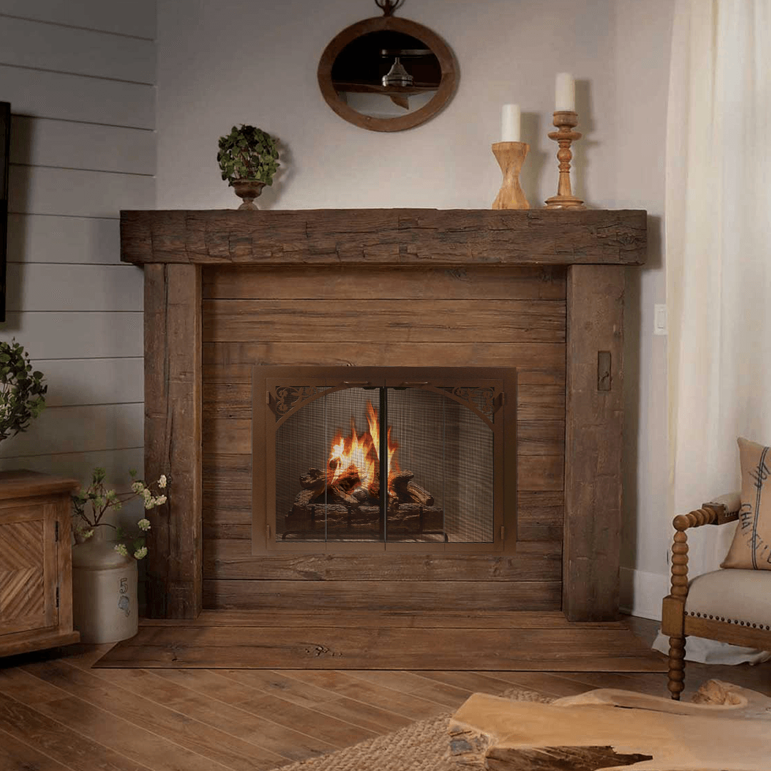 Wooden fireplace with burning fire, candles, and decorative mirror.