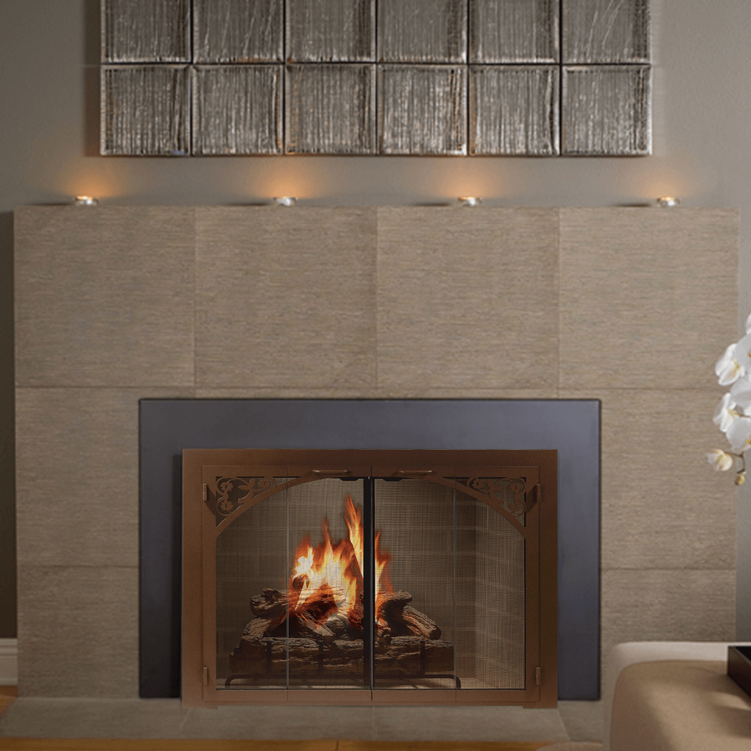 Fireplace with burning fire, bronze screen, and decorative stonework.