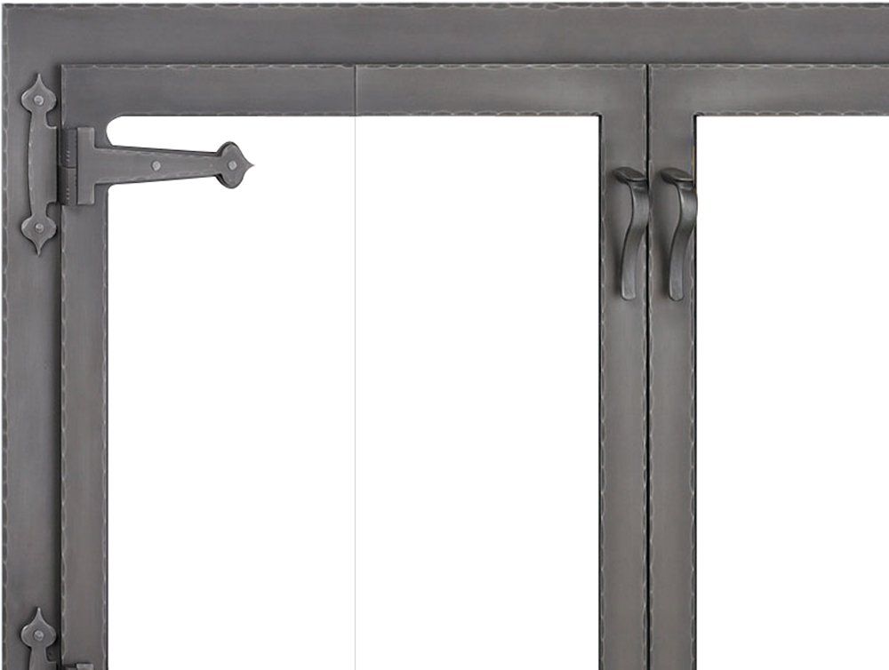 Dark metal double doors with decorative hinges and handles.