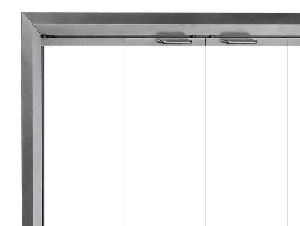 Corner of a metal-framed window with glass panes. Top frame has two handles.