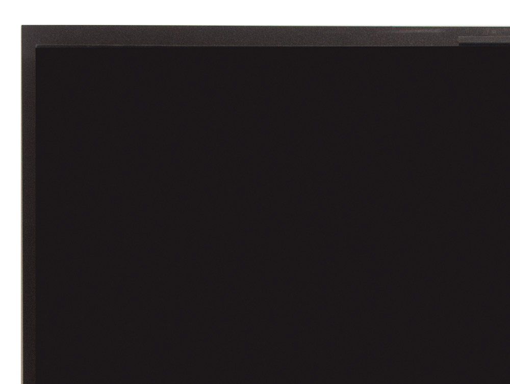 Black computer monitor in a dark room.