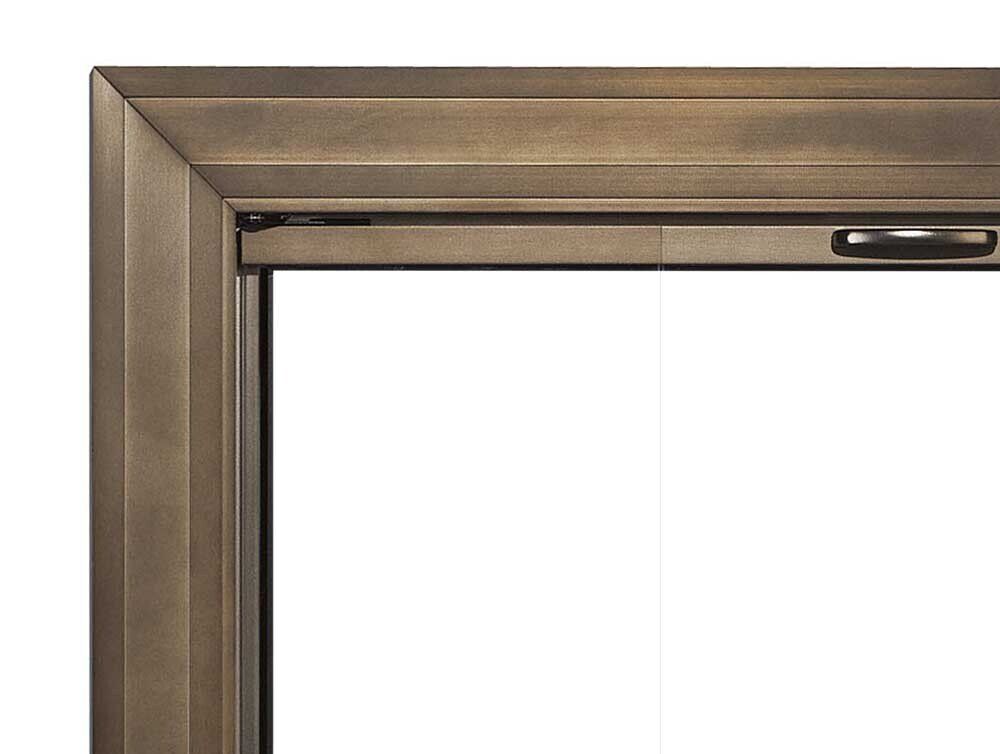 Bronze-colored window frame, corner view, showing beveled edges and a handle.