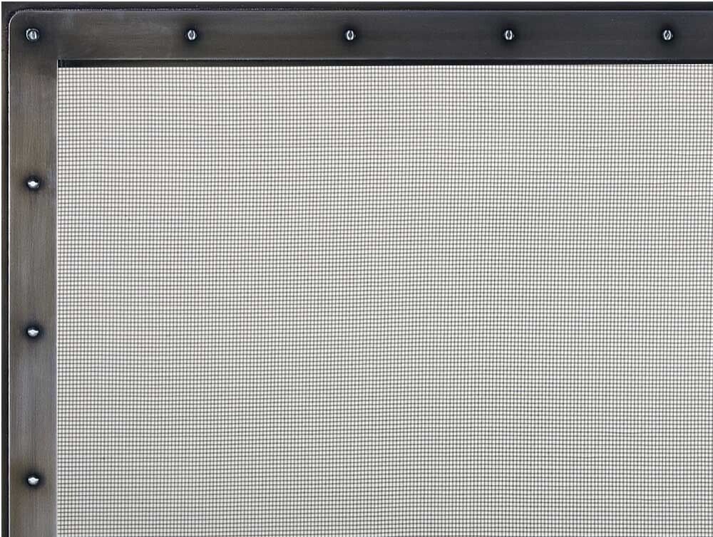 A metal-framed screen with a plaid pattern behind it, held together by rivets.