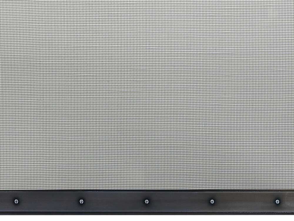 Gray screen with a grid pattern attached to a dark, metal frame with rivets.