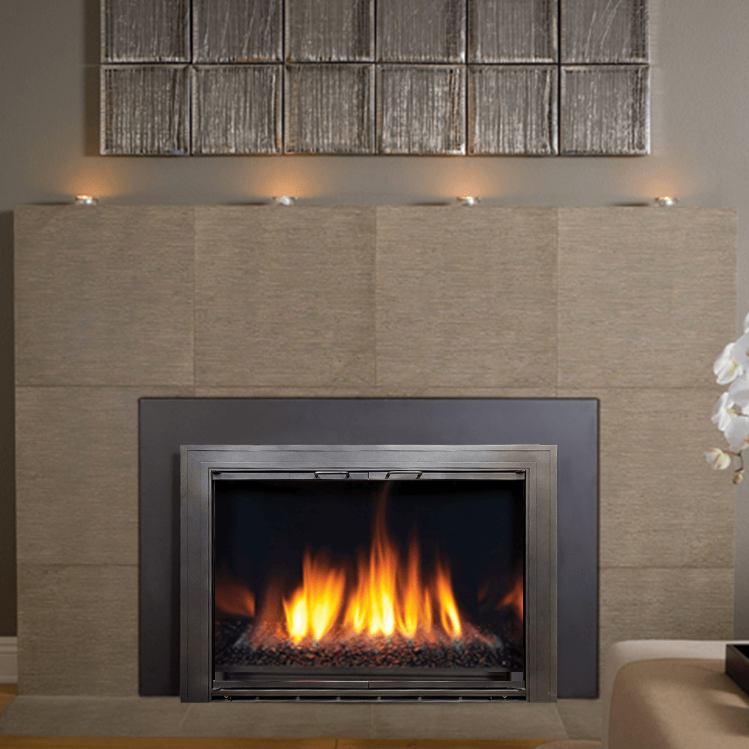 Fireplace with flames, gray metal surround, light tan tiled wall, candles above.