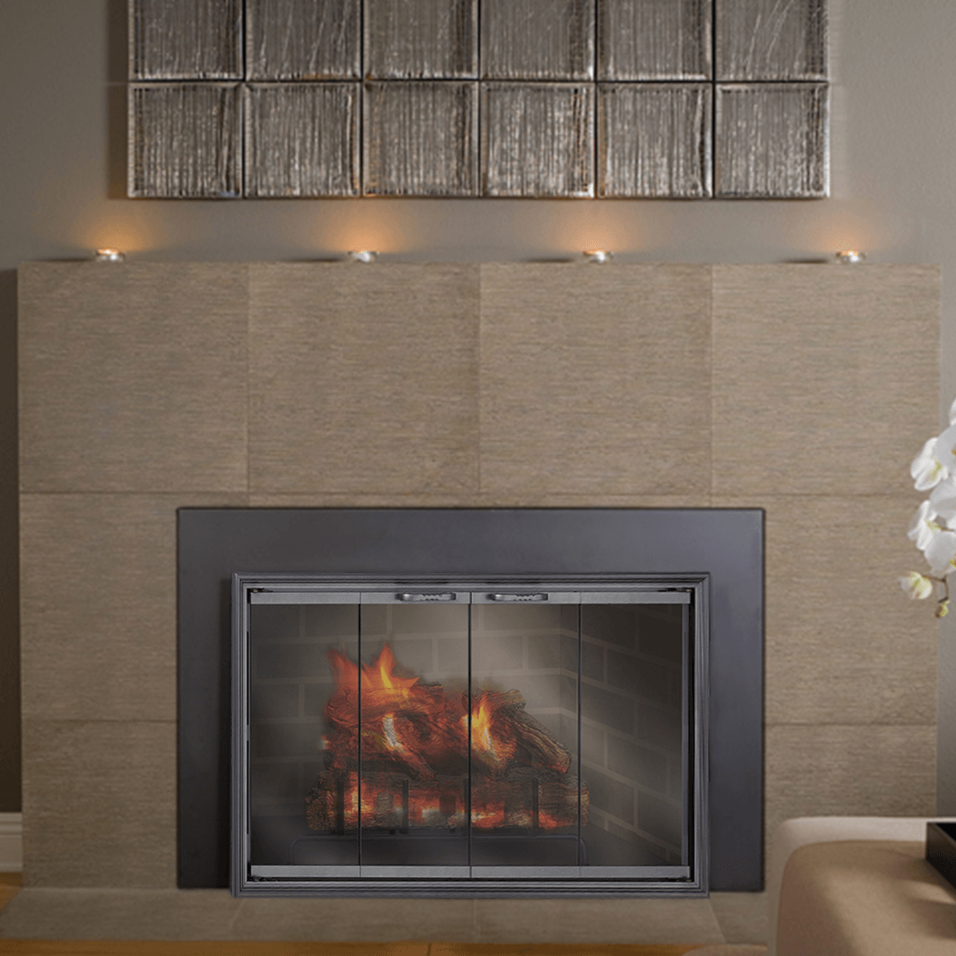 Fireplace with glass doors and burning fire, surrounded by neutral-toned tiles and wall art.
