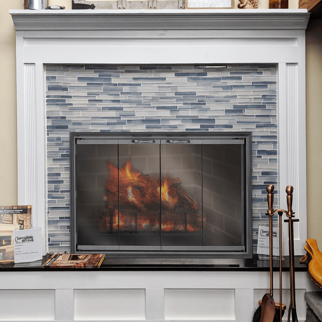 Fireplace with blue tiled surround, white mantel, and burning flames.