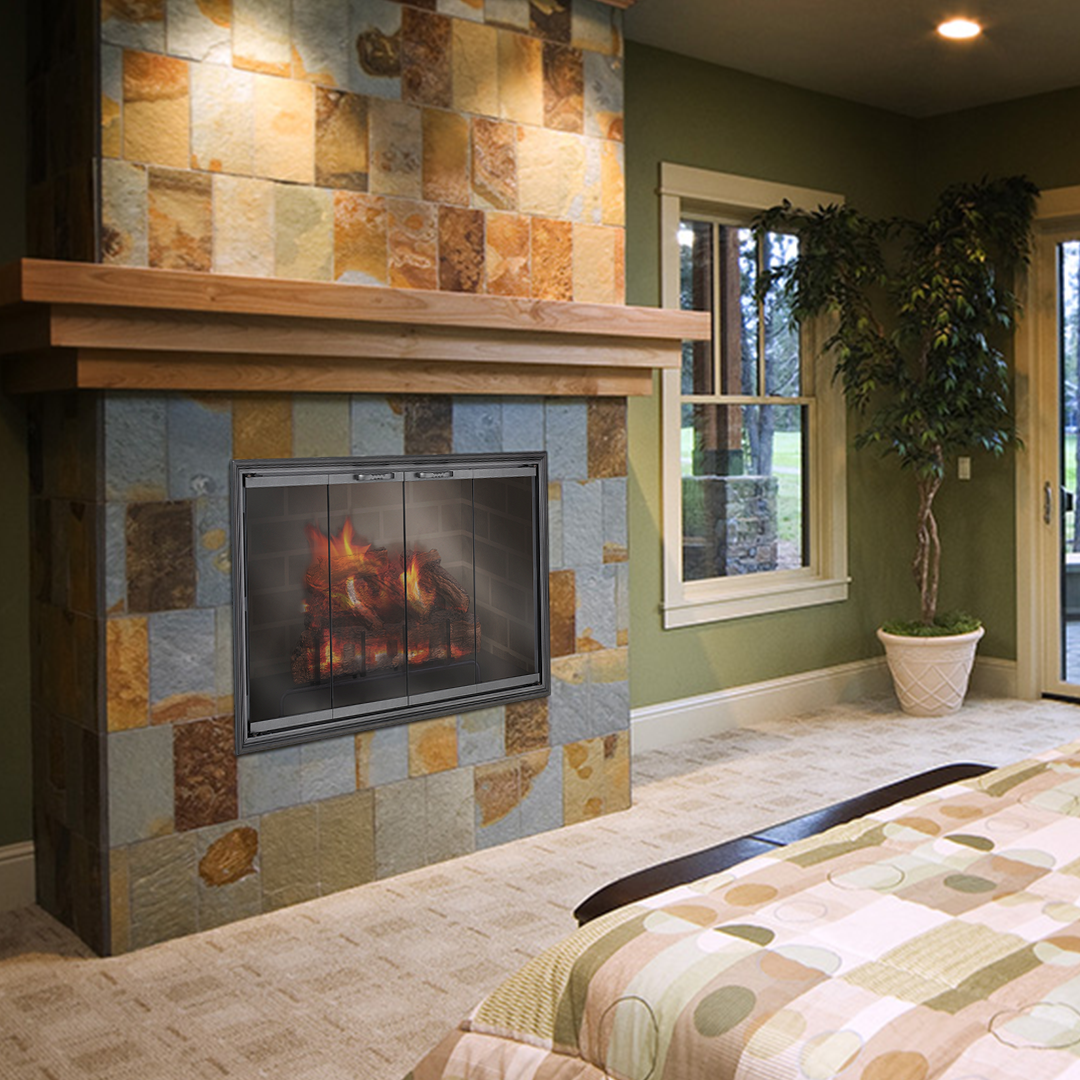Fireplace with a stone facade, wooden mantle, and a fire burning inside, in a green-walled bedroom.