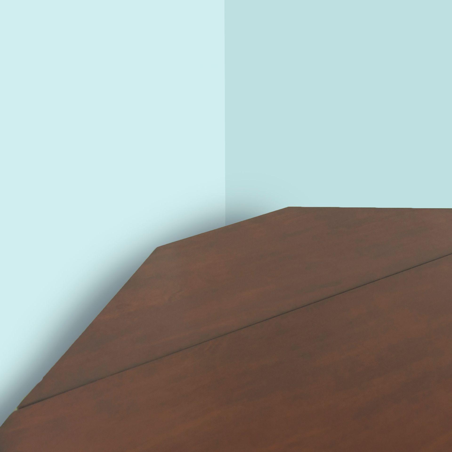 Brown wooden table in a corner with blue walls.