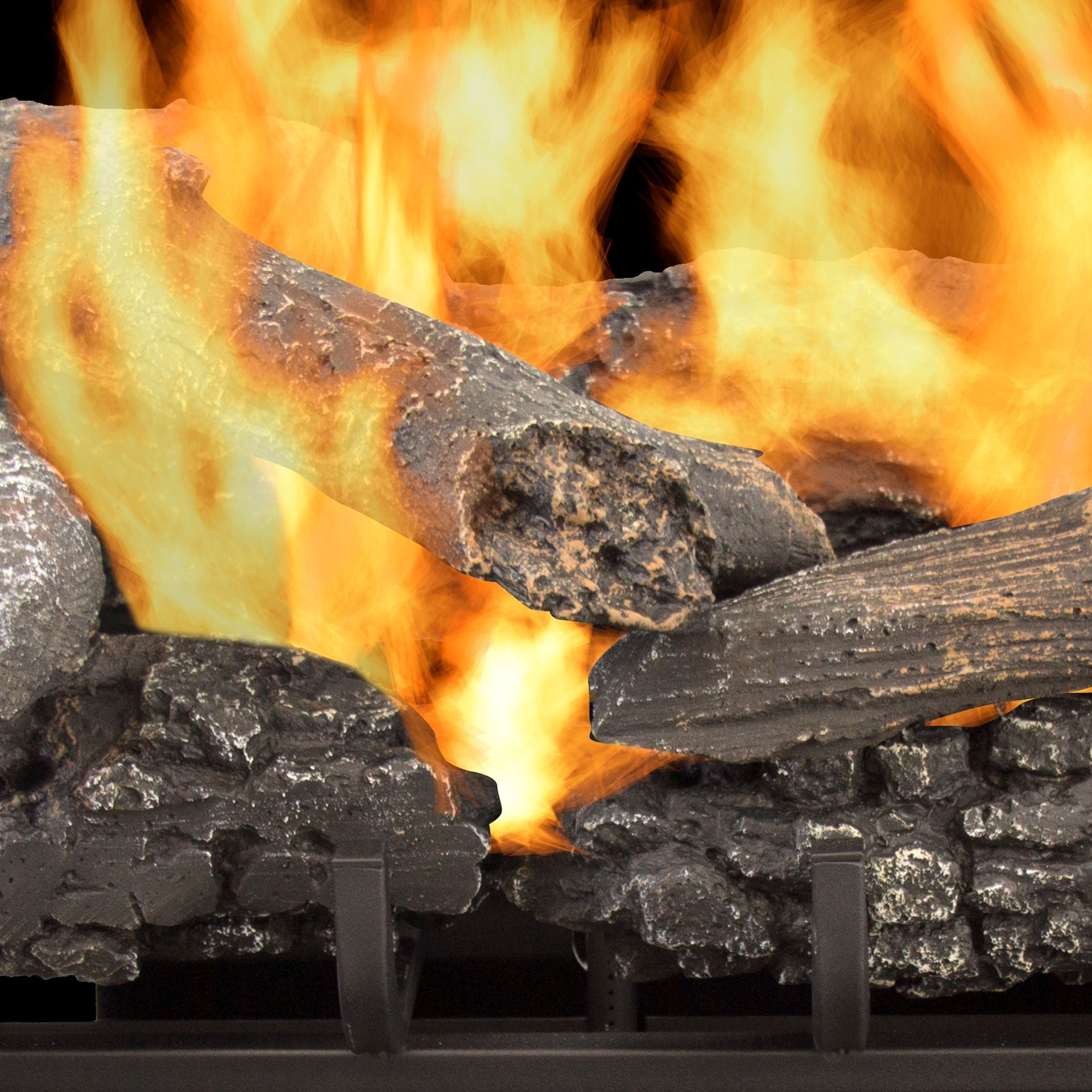 Close-up of a fireplace with burning logs and bright orange flames.