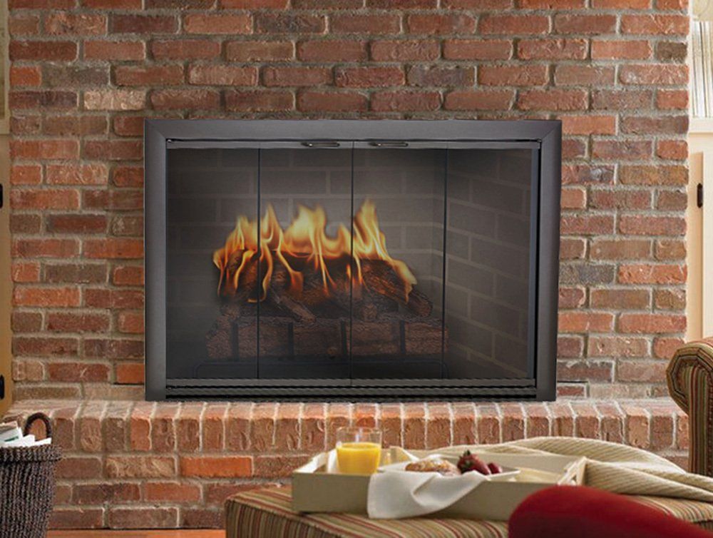Fireplace with fire behind glass doors, set in a brick wall. A tray of food sits in front.