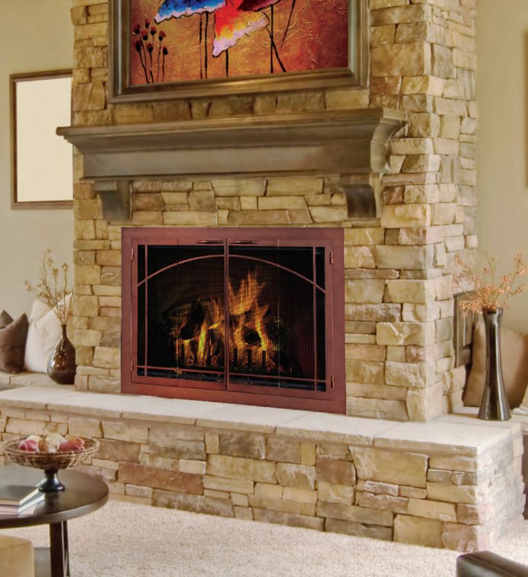 Fireplace with stone facade, dark framed screen, and flames, topped by wooden mantel and artwork.