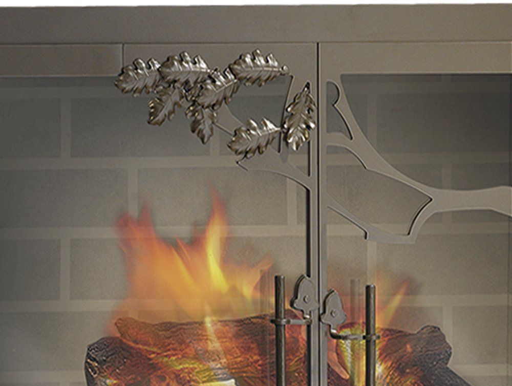 Fireplace screen with decorative leaf accents in front of a burning fire.