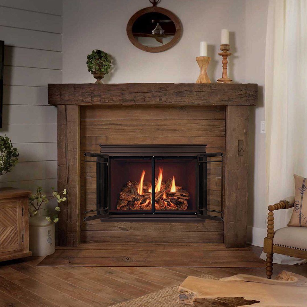 Cozy fireplace with wood mantel and burning flames, surrounded by rustic decor.