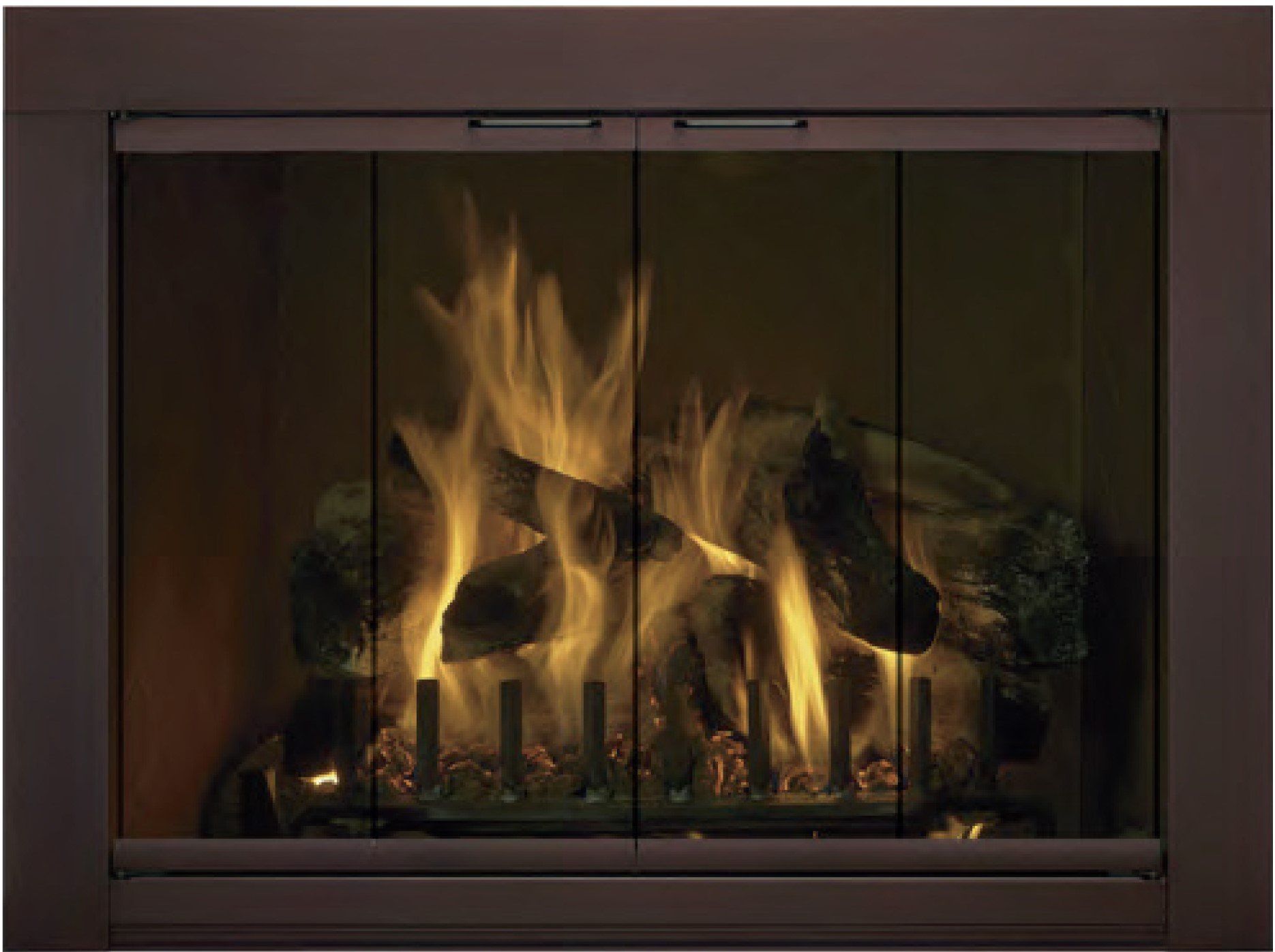 Fireplace with burning logs, behind closed glass doors, with warm orange and yellow flames.
