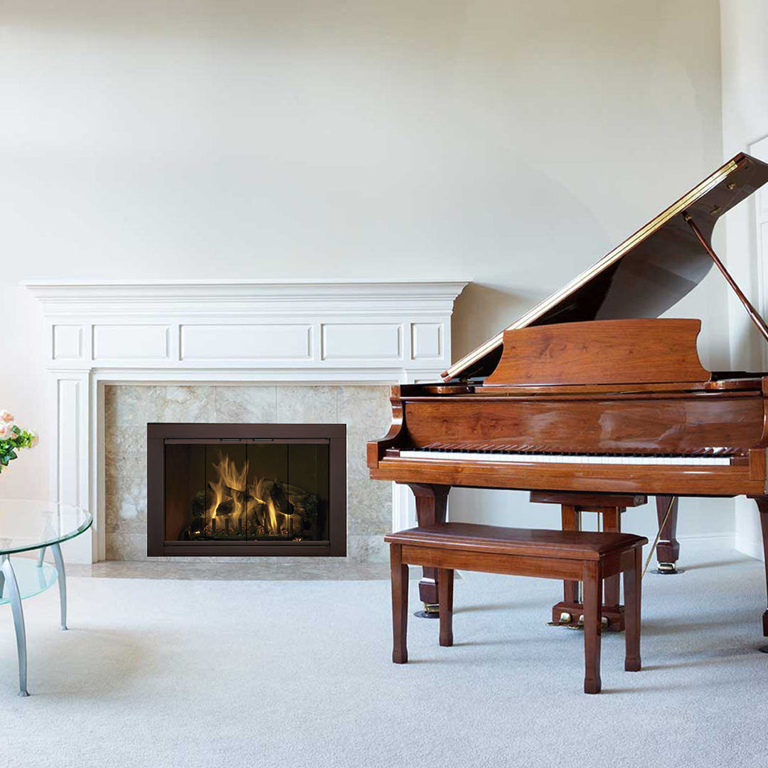 Fireplace with flames and grand piano in a room with white walls and carpet.