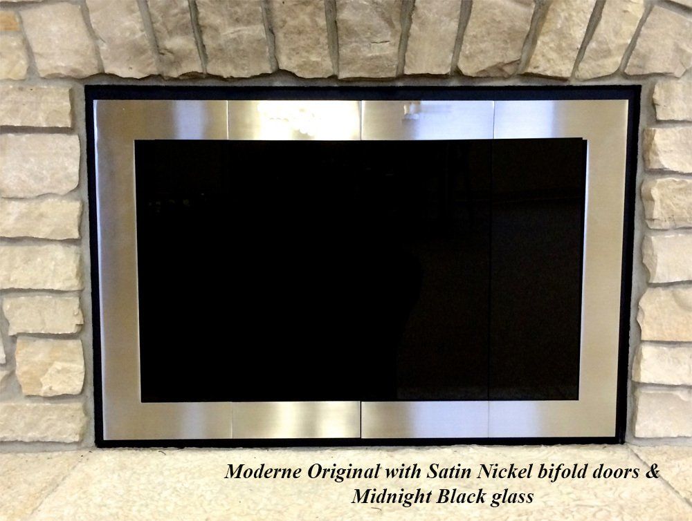 Fireplace with satin nickel bifold doors and midnight black glass, set in a stone surround.
