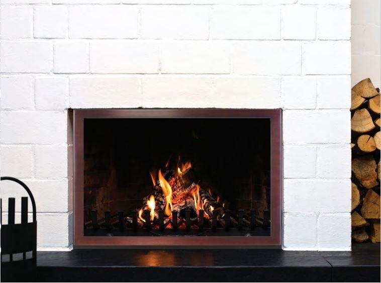 Fireplace with flames burning inside, framed by a dark metal edge, white brick surround.