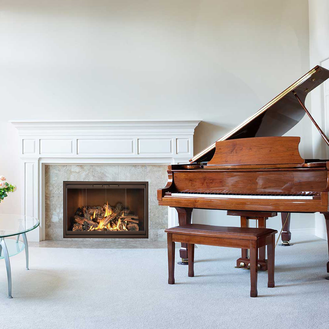 Fireplace with piano in a living room; light walls, brown piano, burning fire, and a bench.