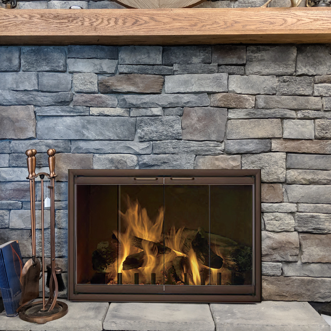 Fireplace with burning flames, stone wall background, and brown wood mantel.