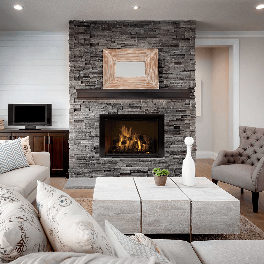 Cozy living room with stone fireplace, neutral colors, and comfortable seating.