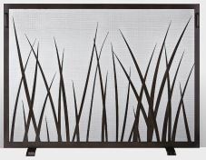Dark metal fireplace screen with cut-out grass design.