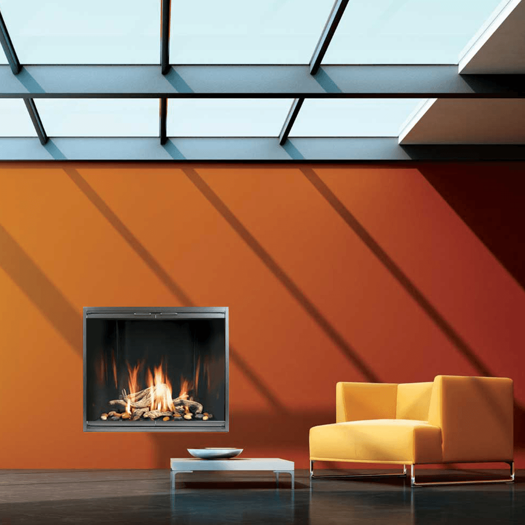 Modern fireplace on orange wall, small white table, yellow chair, skylight.