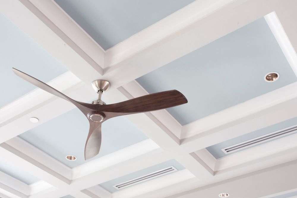 A Ceiling Fan is Hanging From the Ceiling of a Room — Mick Sawtell Electrical Pty Ltd in Palm Beach, QLD