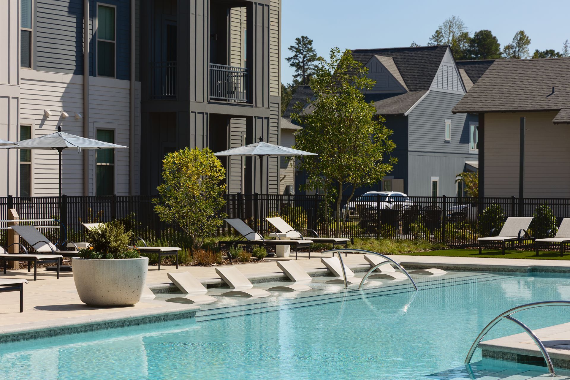 Lounge chairs on the sundeck of the swimming pool at Livano Liberty Park.