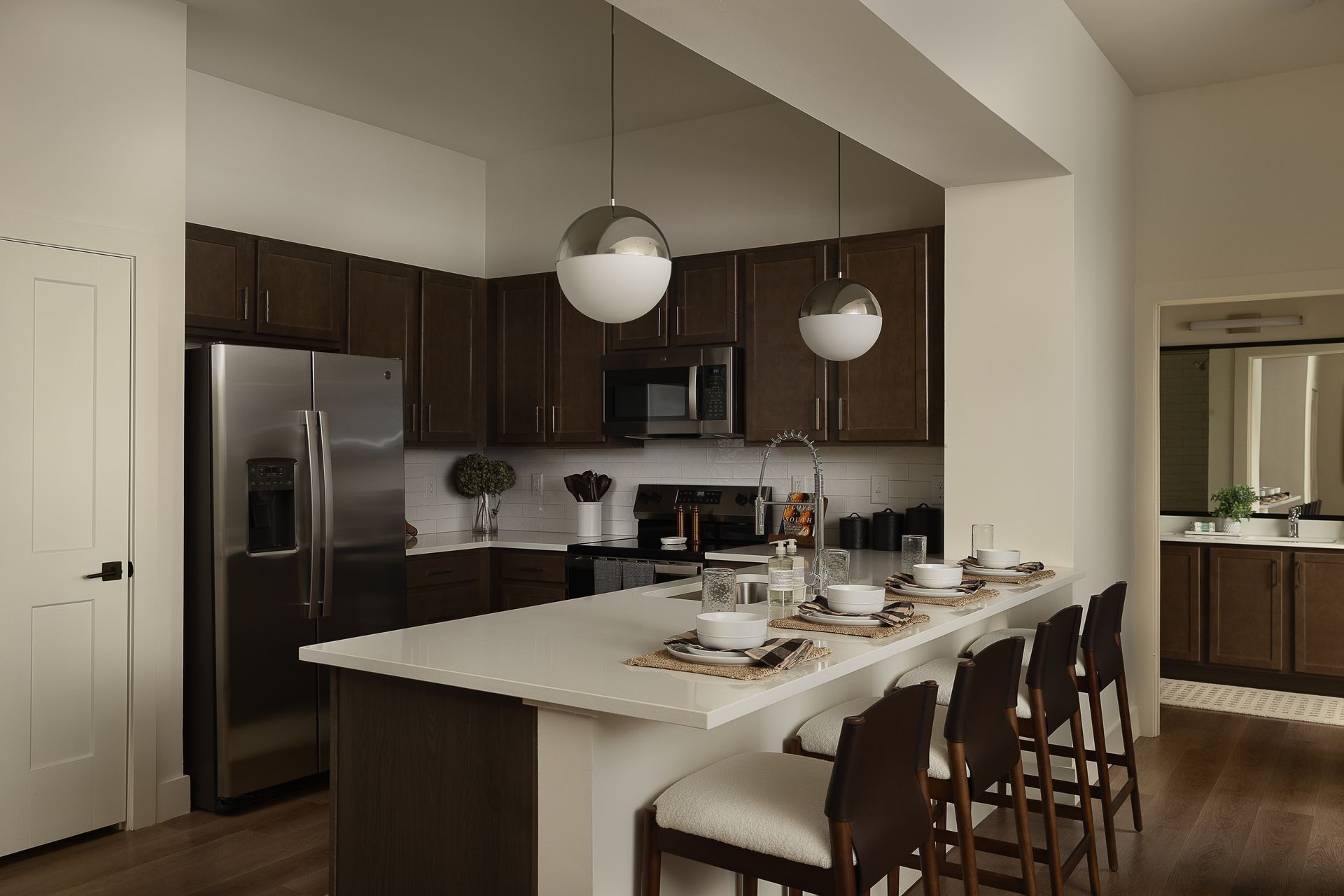Rich dark wood cabinetry in a model home's kitchen at Livano Liberty Park.