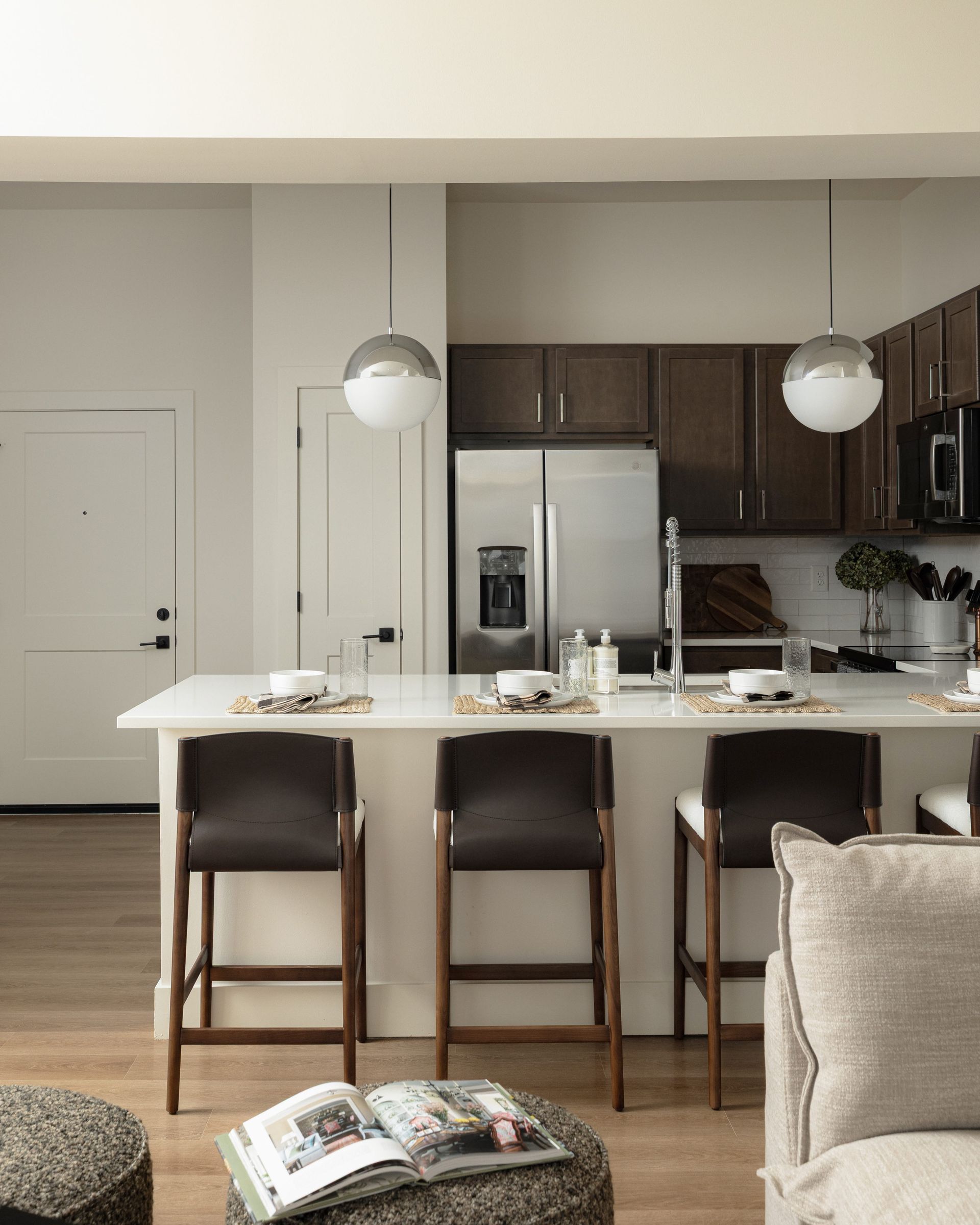 Rich dark wood cabinetry in a model home's kitchen at Livano Liberty Park.