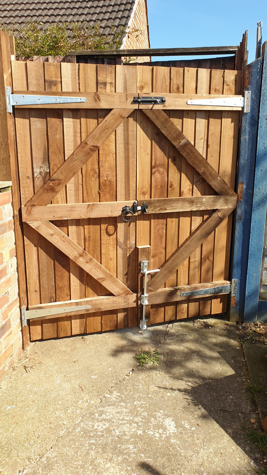 wooden close board double gate with locks and handles