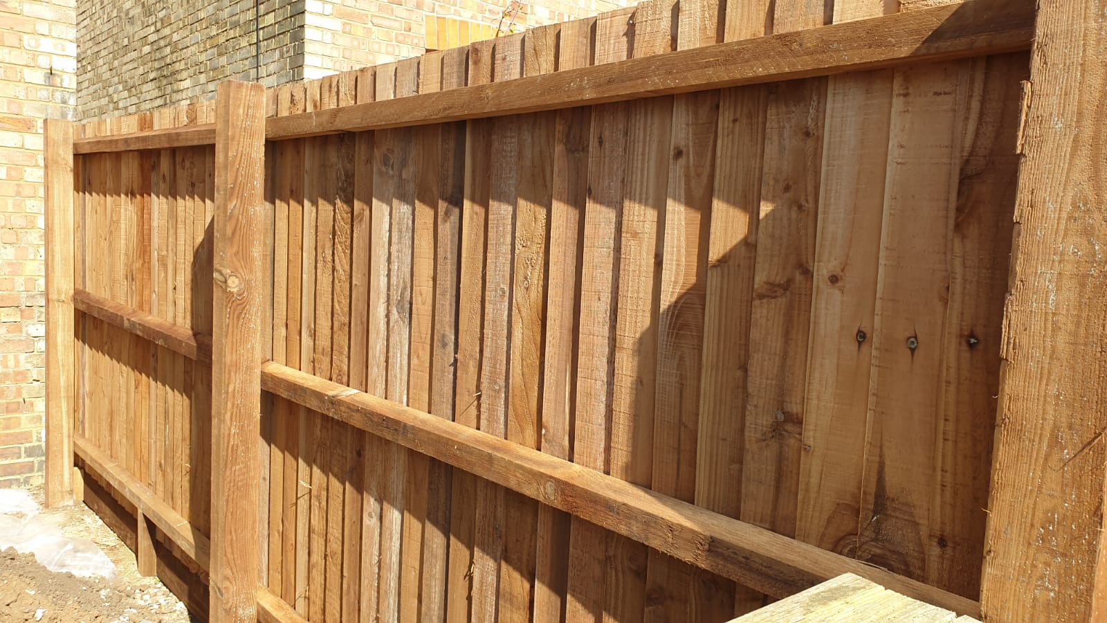 Wooden fence showing posts, cant rails and feather board