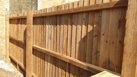 Feather edge wooden fence showing detail of posts and rails