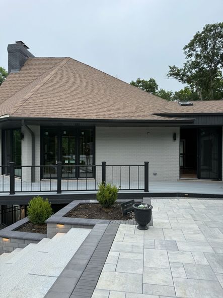 House exterior with a ladder leaning to the roof above the front porch