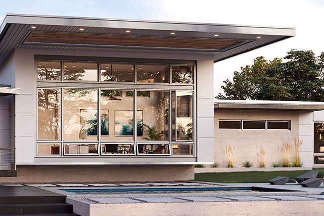 Modern house exterior with large glass windows and a flat overhanging roof