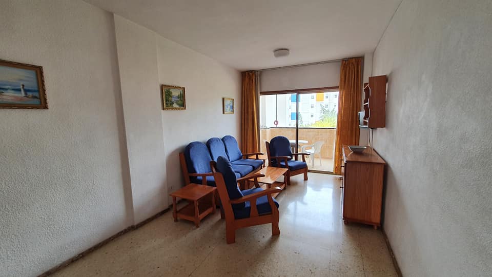 Ein Wohnzimmer mit einer Couch, Stühlen und einem Tisch.