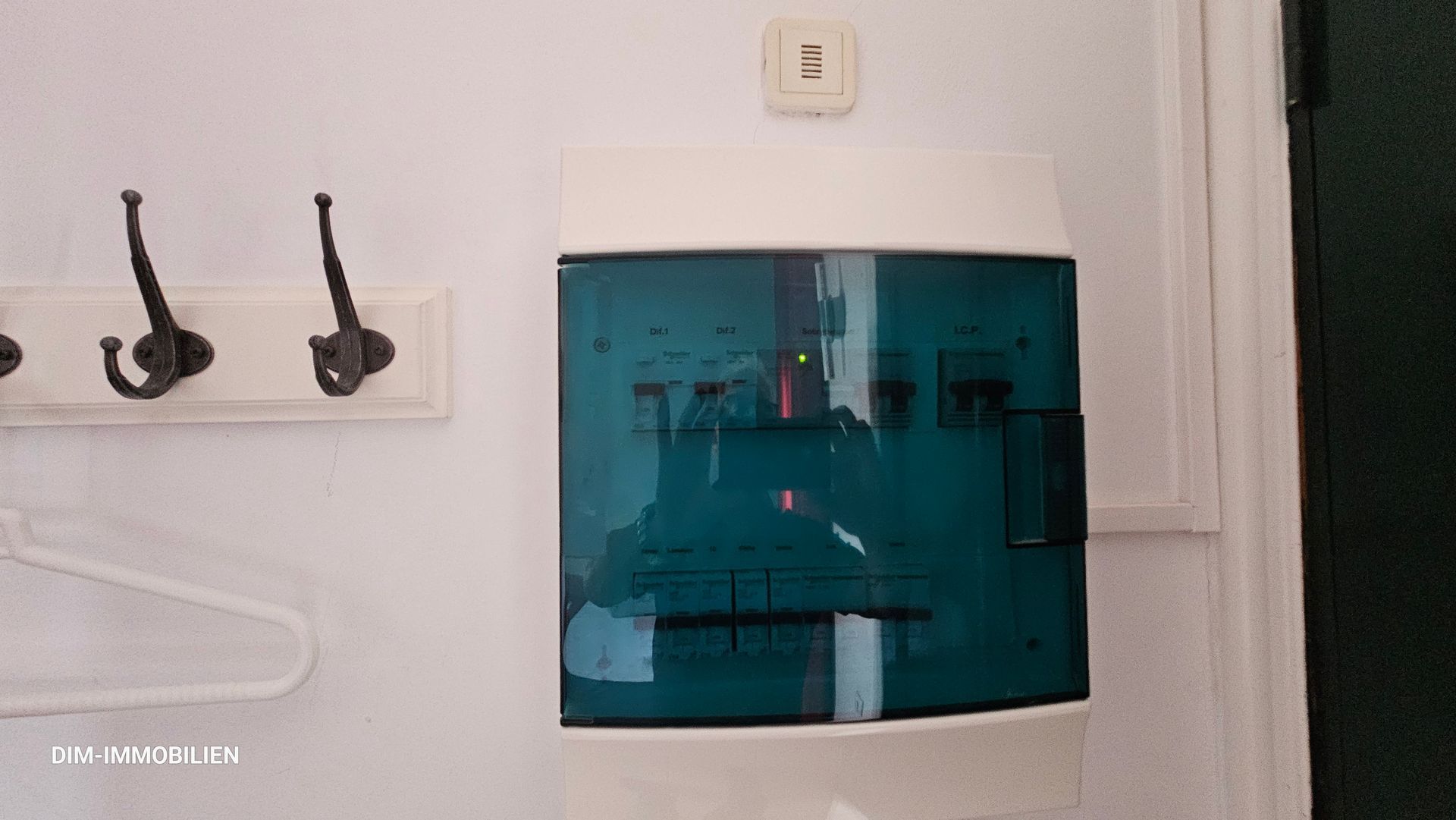 Eine weiße Wand mit einer blauen Box darauf