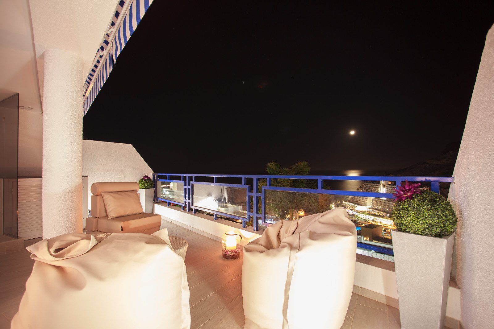 Ein Balkon mit Blick auf das Meer bei Nacht