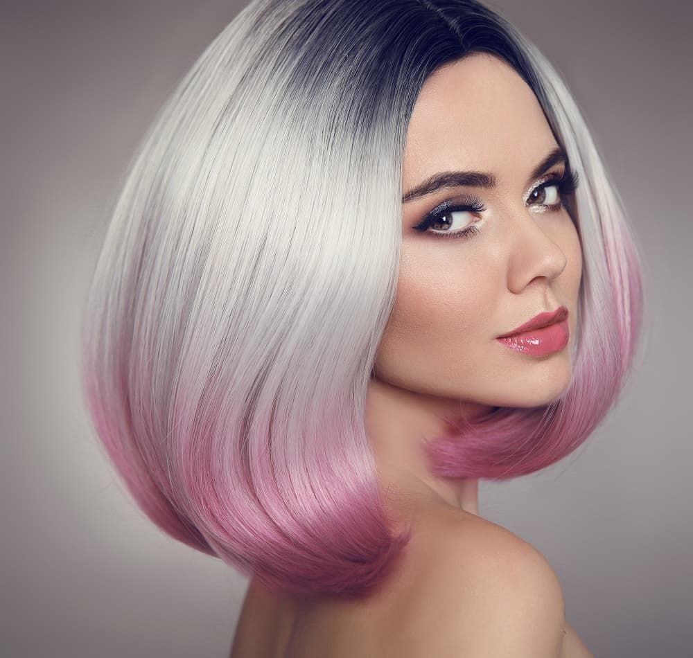 A Woman With Gray and Pink Hair is Wearing a Wig — Xquisite Styles in Dapto, NSW