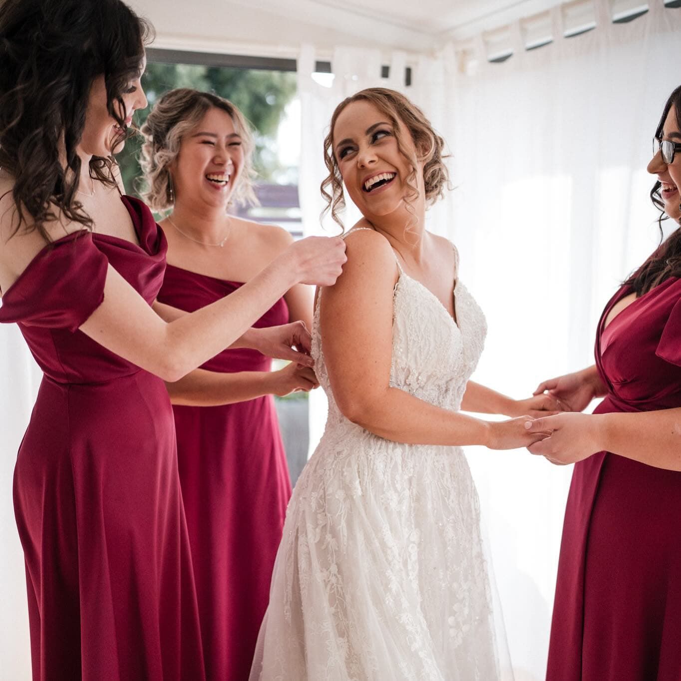 A Bride and Her Bridesmaids Are Posing for a Picture Together — Xquisite Styles in Mount Warrigal, NSW