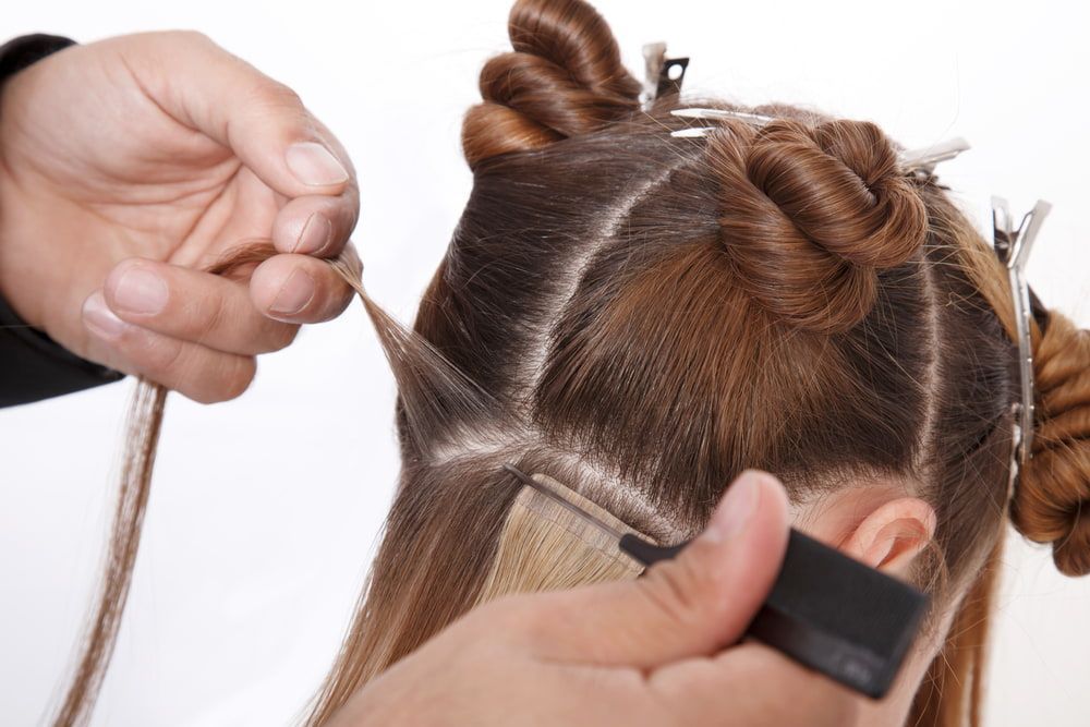 A Woman is Getting Her Hair Done by a Hairdresser — Xquisite Styles in Kiama, NSW